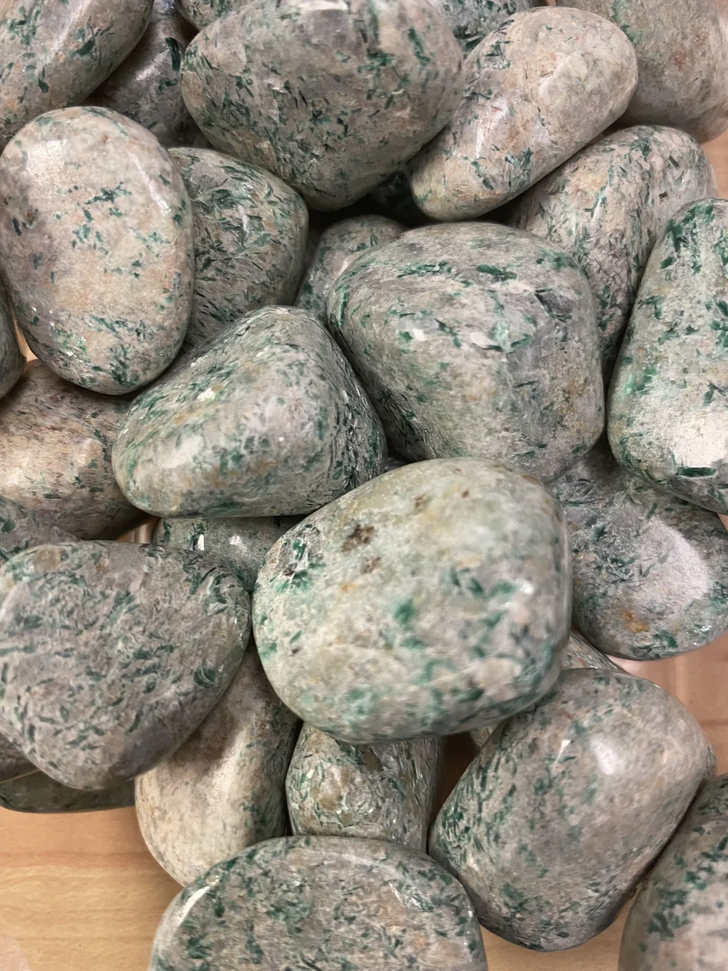 Polished green and cream stones