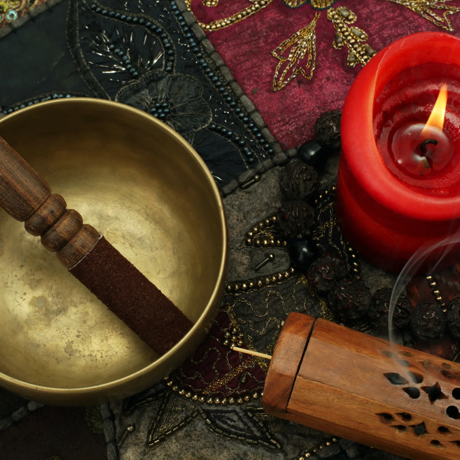 Singing bowl, candle, and incense arranged for spiritual practice